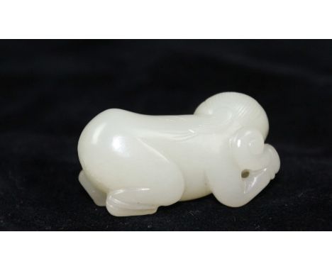 A Chinese greenish white jade pendant of a crouching boy holding a rui sceptre, 4 cm max