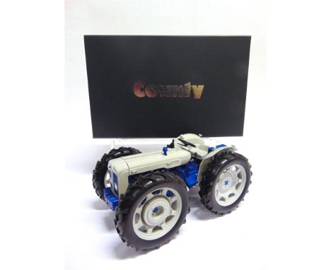 A 1/16 SCALE UNIVERSAL HOBBIES FORDSON COUNTY  pale grey and blue, mint or near mint, with diorama base, boxed.