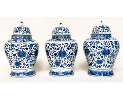 TEMPLE JARS, a set of three, Chinese ceramic blue and white lotus leaf of ginger jar form with lids, 52cm H. (3)