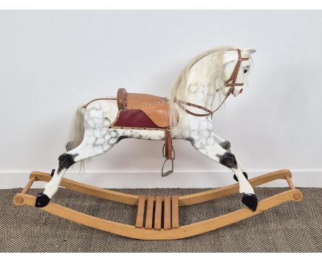 A VICTORIAN STYLE DAPPLED ROCKING HORSE, leather embellishments, horsehair tail and mane, 105cm H x 153cm L.