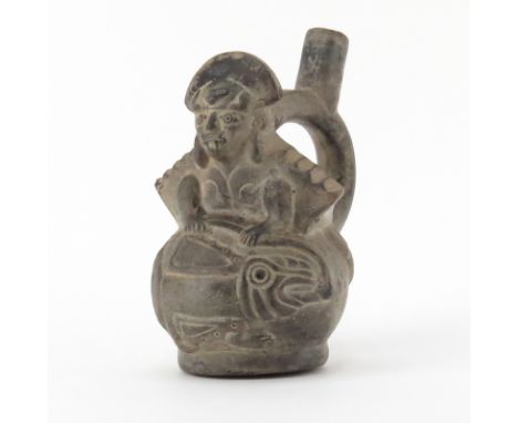 Pre Columbian or Later  Blackware Chimu Inca Figural Pottery Stirrup Vessel. Depicts an effigy molded atop gourd with anthrop