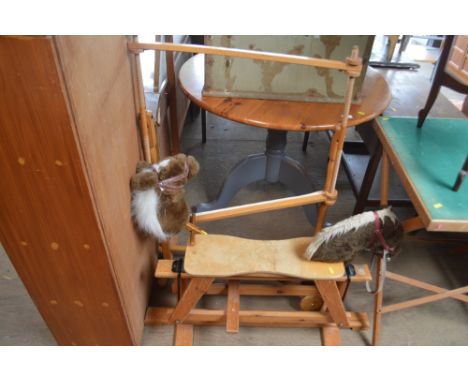 A tapestry frame together with a rocking horse 