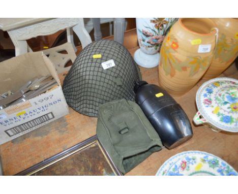 A military helmet and canteen 