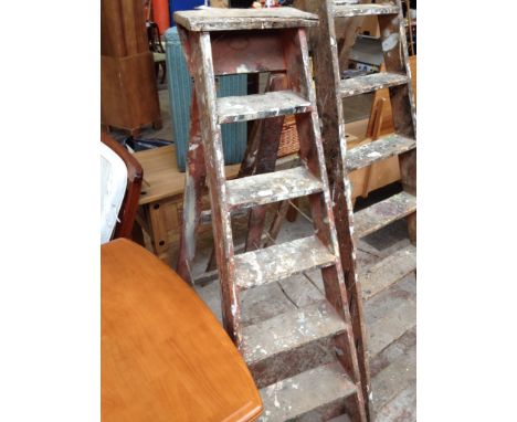 A PAIR OF FOLDING WOODEN STEP LADDERS
