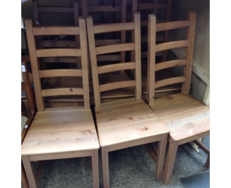 A SET OF EIGHT LADDER BACK PINE CHAIRS