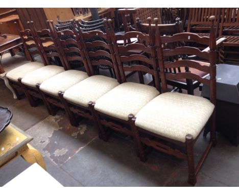 A SET OF SIX OAK LADDER BACK CHAIRS