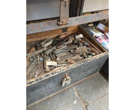 AN OLD WOODEN TOOL CHEST AND TOOLS
