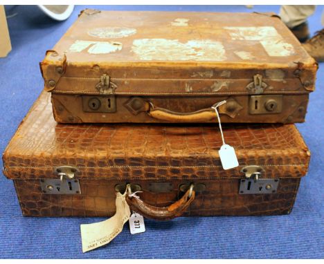 Vintage brown alligator skin suitcase with initials A.A.P. and another brown leather suitcase with remnants of various paper 