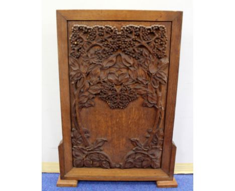 Glasgow School, style, carved oak firescreen with foliate decoration, 64cm.