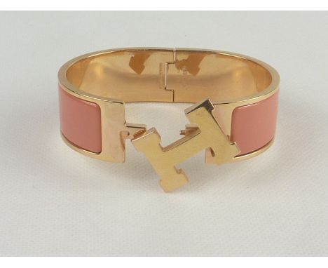 Hermes "Clic Clac" rolled gold and pink enamel bracelet. Condition Report. 6cm x 4.75cm. (Oval)