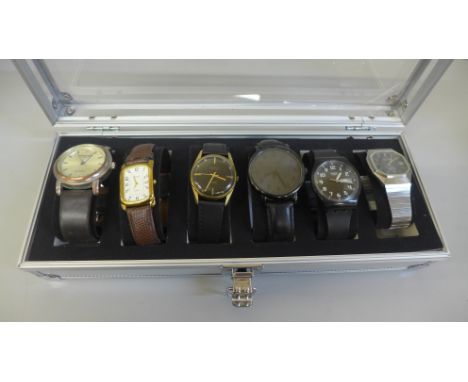 Six wristwatches in a case, including Swatch and Timex 