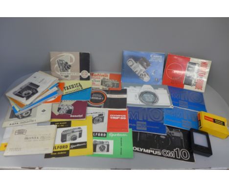 A box of vintage camera booklets and a pocket viewer 