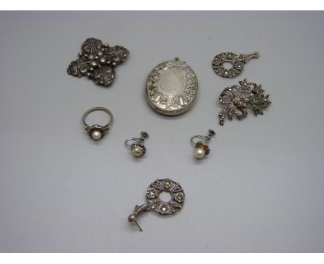 A silver Candida brooch, a pair of silver and marcasite earrings (one pin missing), a silver and marcasite brooch, a vintage 