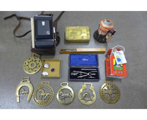 A WWI Christmas tin, a collection of horse brasses, prefect and school badges, a Royal Doulton W.G. Grace character mug, Zeis