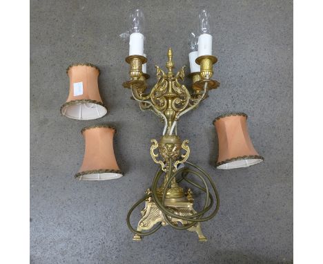 An Ormolu four arm table lamp with deep apricot shades **PLEASE NOTE THIS LOT IS NOT ELIGIBLE FOR POSTING AND PACKING** 