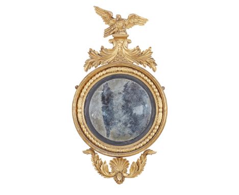 REGENCY GILTWOOD CONVEX MIRROR  EARLY 19TH CENTURY   the circular mirror plate in a black slip and bead moulded frame marked 