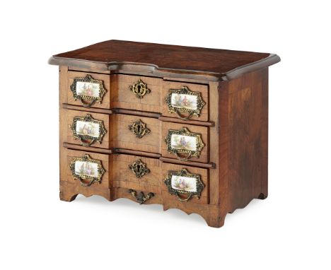MINIATURE CONTINENTAL PORCELAIN MOUNTED WALNUT COMMODE  LATE 19TH/ EARLY 20TH CENTURY   the shaped rectangular crossbanded to