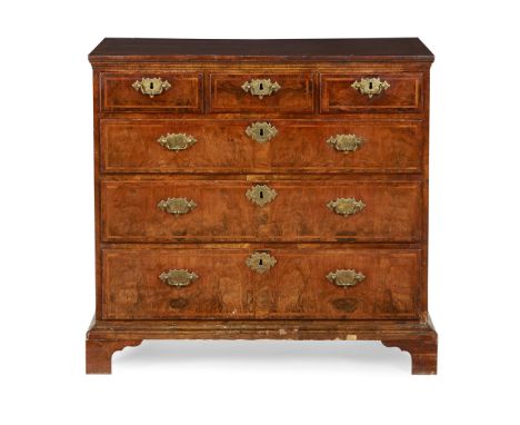 GEORGE I WALNUT CHEST OF DRAWERS  EARLY 18TH CENTURY, AND LATER   the later quarter veneered and crossbanded top with feather