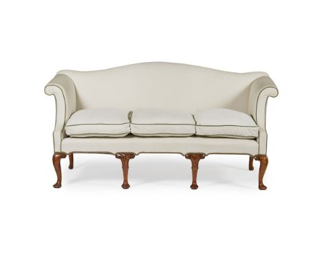GEORGE II STYLE WALNUT SOFA  EARLY 20TH CENTURY   the hump back above a three-cushion seat and outscrolled arms, raised on ei