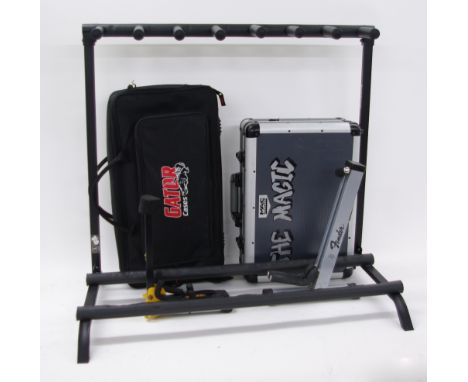 Rockstand seven position folding guitar stand; together with a Hercules guitar stand, a Fender guitar stand, a Gator pedal gi