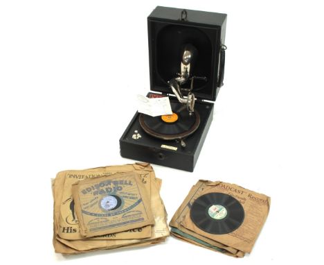 Decca portable gramophone bearing a C.H. Perrett Music Store, Salisbury dealer plaque, with spare needles and a selection of 