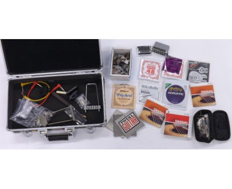 Small selection of guitar spares and accessories including a Fender bridge block, tuners, knobs, tailpieces, strings and a gu