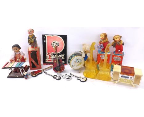 Selection of vintage kitsch and novelty musical items to include two boxed clockwork musical monkeys, a Premier Drum dealer s