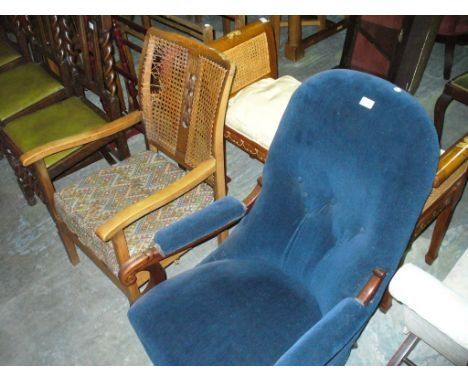 A Victorian walnut and button back low seat drawing room chair with padded arms and scroll terminals and an early 20th centur