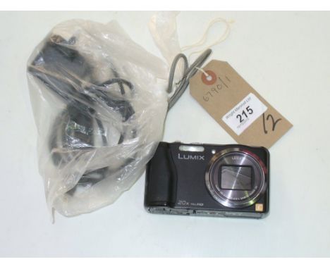 A Panasonic lumix  DMC - TZ30 digital camera and charger.
