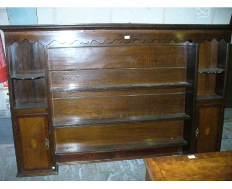 A George III Oak and Mahogany Inlaid Enclosed Plate Rack.
With a cavetto cornice above an inlaid and shaped fret cut frieze w