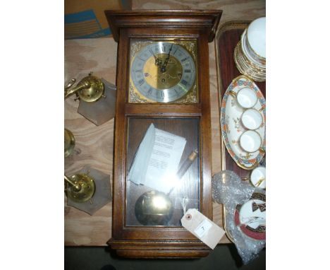 A 20th Century oak cased wall clock with a gilt metal dial and silvered bezel signed  M Laverton with a 3 train movement and 