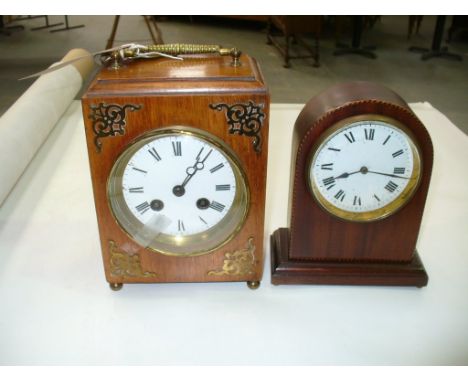 An Early 20th century brass embellished mantel clock with a white enamelled dial , two train movement and an Edwardian mantel