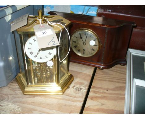 A Kundo reproduction torsion clock within a hexagonal glass case and an early 20th century mahogany cased mantel clock with a