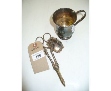 A Silver baluster mug, Sheffield 1909 ( 5.02 ozs ) , a silver whiskey decanter label and a pair of silver plated grape scisso