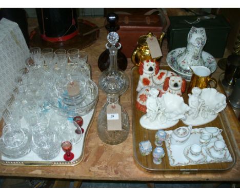 An Amber coloured glass decanter and stopper, a cut glass bottle shaped decanter with a mushroom shaped stopper, a third deca