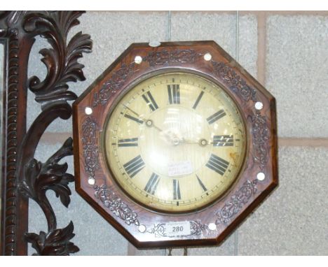 A Victorian octagonal simulated rosewood wall clock inlaid with mother of pearl roundels , white enamel dial and two weights.