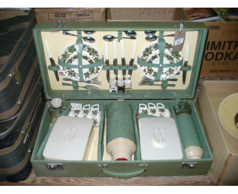 A Vintage Sirram fitted picnic case c/w leaf pattern tea service, flasks and tupperware boxes.