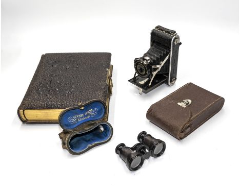 A photograph album, Brownie camera and a pair of opera glasses