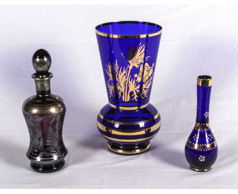 Two blue and gilt glass vases and a decanter