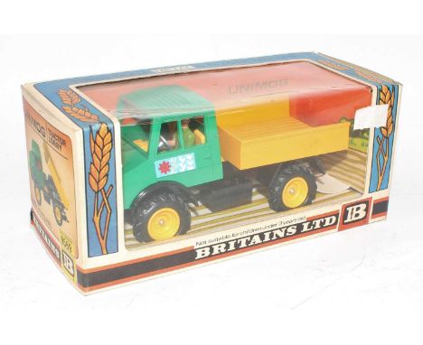 A Britains No. 9569 Unimog tractor lorry comprising of green cab, black chassis and yellow back, housed in the original windo
