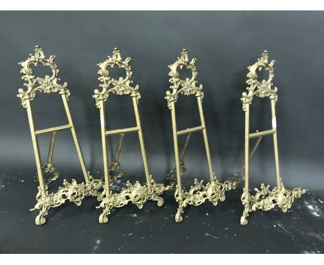 19th Century English School. An Ornately Cast Brass Easel, 21.25" x 9.5", and three companion pieces, a set of four (4).