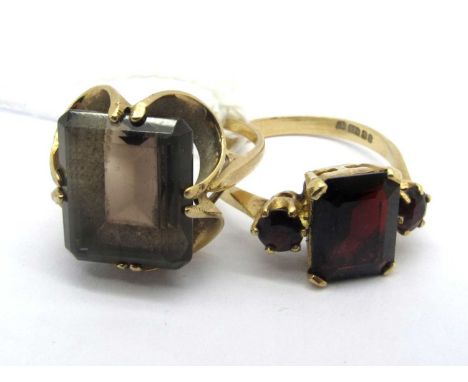 A 9ct Gold Smoky Quartz Dress Ring, rectangular claw set within openwork setting, between plain shoulders (finger size K); A 