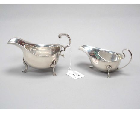 A Hallmarked Silver Sauce Boat, JD&amp;S, Sheffield 1929, with wavy edge and flying scroll handle, on three hoof feet; A Smal