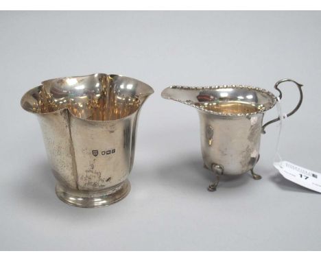 A Hallmarked Silver Jug, Walker &amp; Hall, Sheffield 1930, with bead and reel edge, on three hoof feet; A Hallmarked Silver 