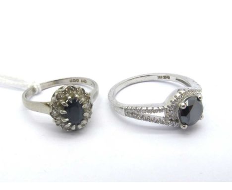 A Platinum Cluster Dress Ring, oval claw set to the centre (finger size N); A Modern Dress Ring, stamped "CZ 925" (finger siz