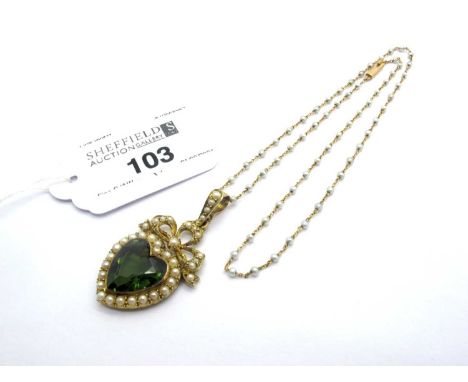 An Edwardian Heart Shape Green Tourmaline and Pearl Set Pendant, collet set within pearl set border, below pearl set bow surm