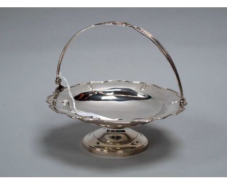 A Hallmarked Silver Swing Handled Footed Dish, Birmingham 1920, of shaped circular form with shaped swing handle, on circular