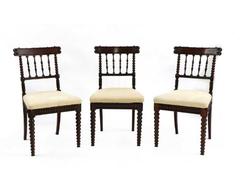 Three rosewood side chairs, 19th century, with carved tablet backs, bobbin turned supports, drop-in seats, with tapering bobb