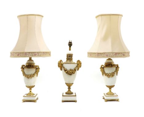 A pair of Classical style white marble and gilt metal urn form table lamps, with twin mask handles on plinth bases, 32cm high