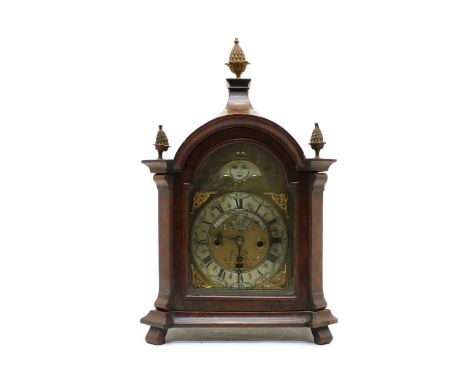 A walnut mantel clock, the broken arch dial with moon phase and date apertures, an applied silvered chapter ring, inscribed J